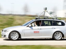 People read newspaper while sitting in complete automatically driving development car by German auto parts supplier Robert Bosch in Abstatt