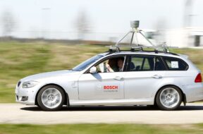 People read newspaper while sitting in complete automatically driving development car by German auto parts supplier Robert Bosch in Abstatt