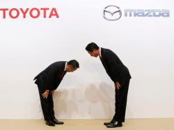Toyota Motor President Akio Toyoda and Mazda Motor President Masamichi Kogai bow at a joint news conference in Tokyo