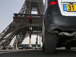 A car drives near the Eiffel tower in Paris during unusually high levels of pollution in France