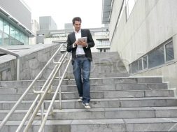 man-walking-down-stairs-tablet-footage-014830136_prevstill