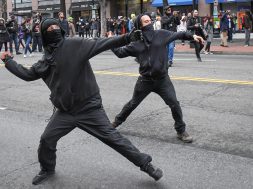 Protestors throw rocks at police during a protest near the inauguration of President Donald Trump in Washington