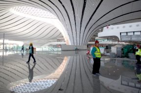 Construction workers are seen inside the terminal hall of the Beijing Daxing International Airport under construction in Daxing district, Beijing