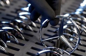 FILE PHOTO: An employee of German car manufacturer Mercedes Benz prepares the company’s logo prior to its installation at the A-class production line at the Daimler factory in Rastatt