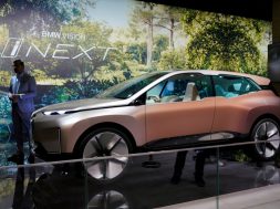 FILE PHOTO: Man stands next to a BMW’s Vision iNEXT displayed during the media day for Shanghai auto show