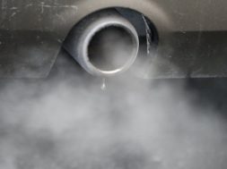 An exhaust emits fumes as a car is driven through Richmond in London