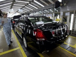 FILE PHOTO: An employee checks on newly produced cars at a Toyota factory in Tianjin