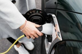woman s hand plugging in a charging lead to her electric car Stockholm, Stockholm County, Sweden PUBLICATIONxINxGERxSUIx