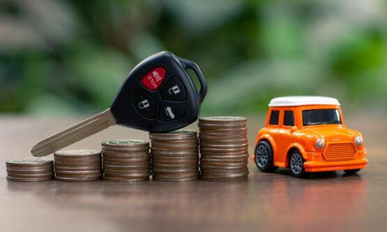 Car key on money coin with car model on table, Sell and Buy car concept.