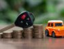 Car key on money coin with car model on table, Sell and Buy car concept.