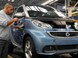 An employee at the Smart Cars factory works on the Smart Fortwo assembly line in Hambach