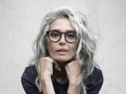 Lady-with-long-grey-hair-wearing-round-black-glasses