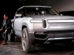 FILE PHOTO: Rivian’s CEO, Scaringe, with the R1T all-electric pickup truck at LA Auto Show in Los Angeles