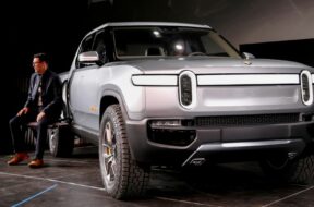 FILE PHOTO: Rivian’s CEO, Scaringe, with the R1T all-electric pickup truck at LA Auto Show in Los Angeles