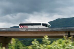Spain, Elgoibar, Bus on elevated road in landscape