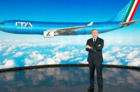 ITA Airways Chairman Alfredo Altavilla poses with the image of the new livery for the carrier’s jets