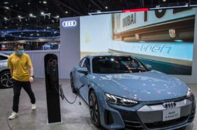 December 3, 2021, Nonthaburi, Thailand: A visitor walks past a Audi e-tron GT car displayed at the Motor Expo..The 38th