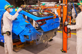 Indiana Auto Plant associates use a lift assist device to install the hatchback to the all-new 2022 Honda Civic Hatchback.