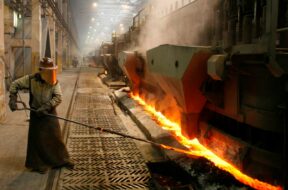 A worker serves an electrolysis furnace in the RUSAL aluminium smelter in Krasnoyarsk