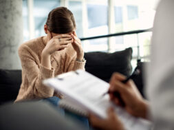 Depressed woman having psychotherapy session at doctor’s office.